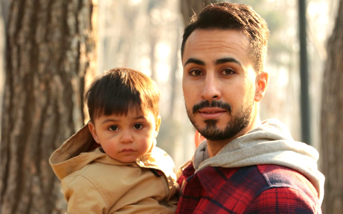 A father holding his young son