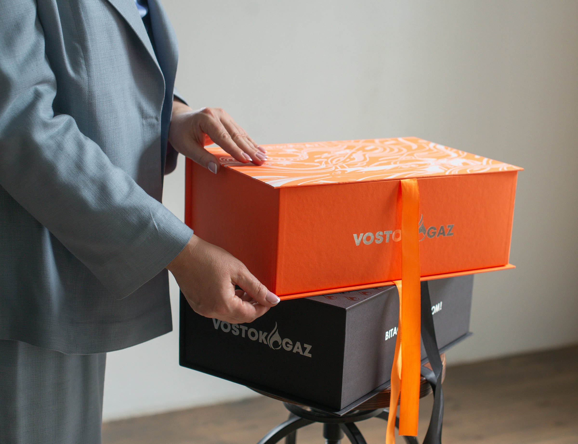 Opening a branded orange gift box