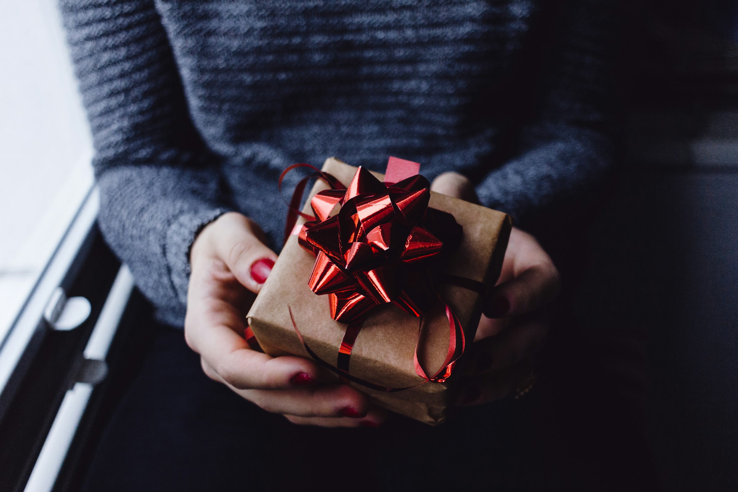 Holding a wrapped personalised gift